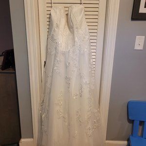 Strapless white wedding dress with sequences and lace up back.